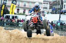 Four wheels off the ground as a quad bike rider attempts one of the artifical jumps