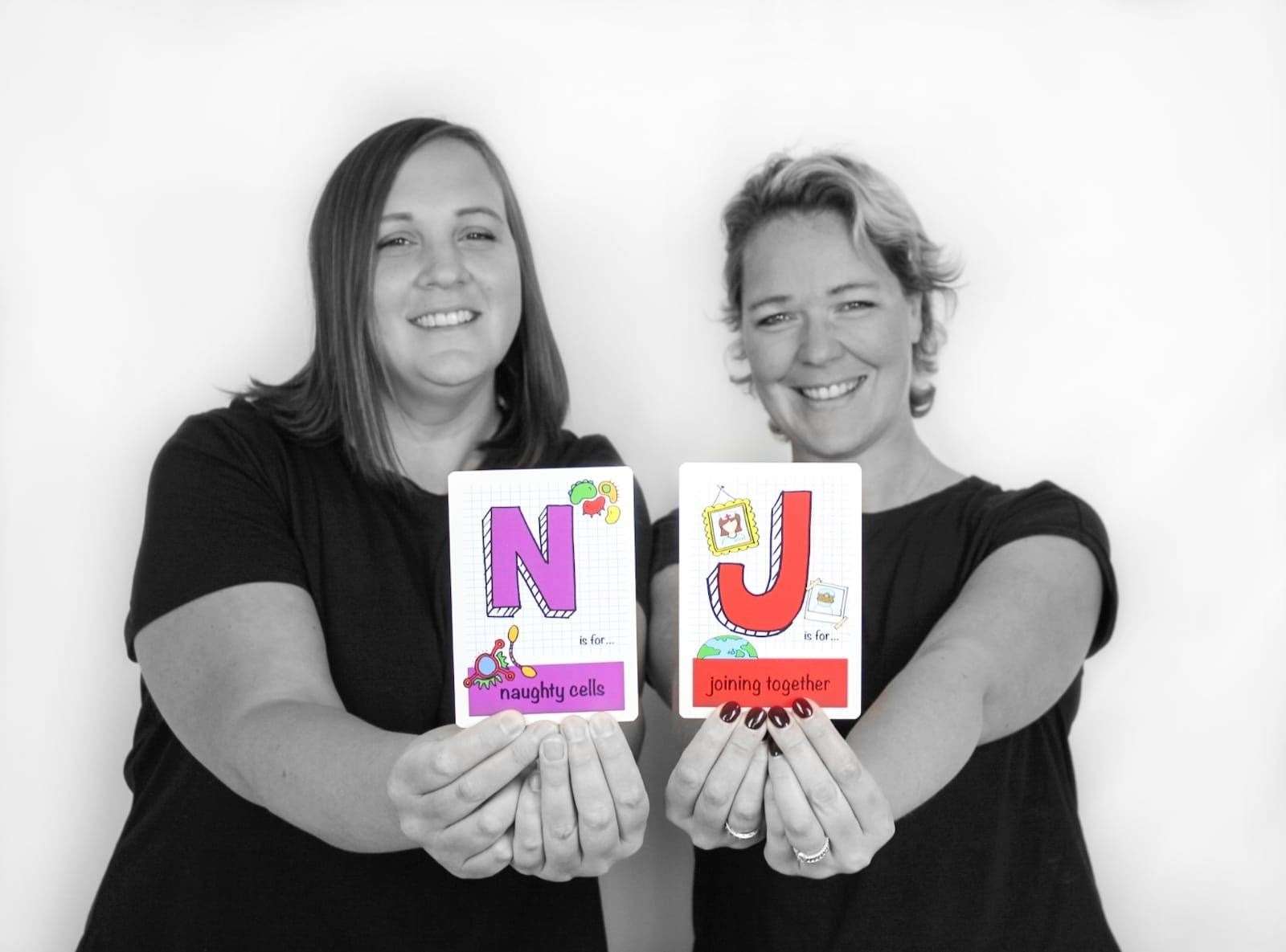 Nic and Jen with their flash cards created in support with Cancer Research UK