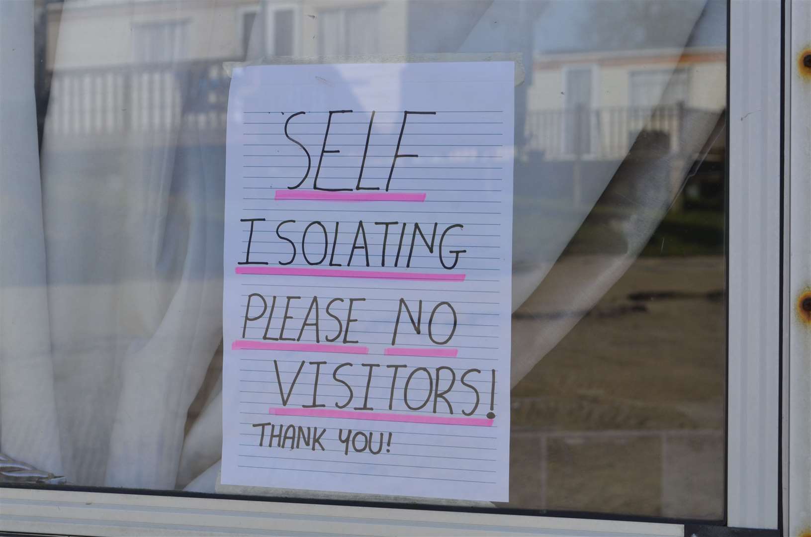 Self-isolating caravan owners put posters in their windows at Elmhurst Holiday Park on the Isle of Sheppey