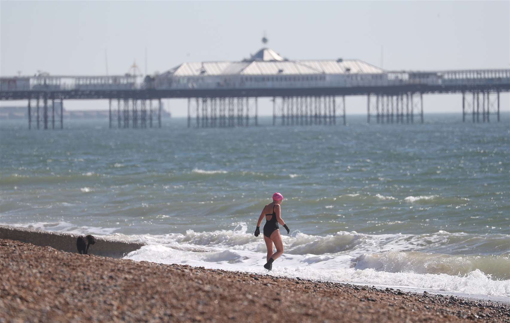 A person goes for a swim in the sea off of Brighton beach (Andrew Matthews/PA Wire)