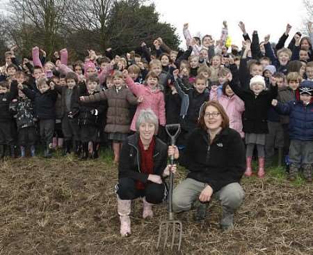 Chairman of governors Ylva Blid-MacKenzie, right, and deputy head Lindsay Roberts with pupils in the allotments. Picture: DAVE DOWNEY