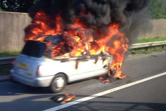 This taxi caught fire on the M25. Picture: @AntBenn