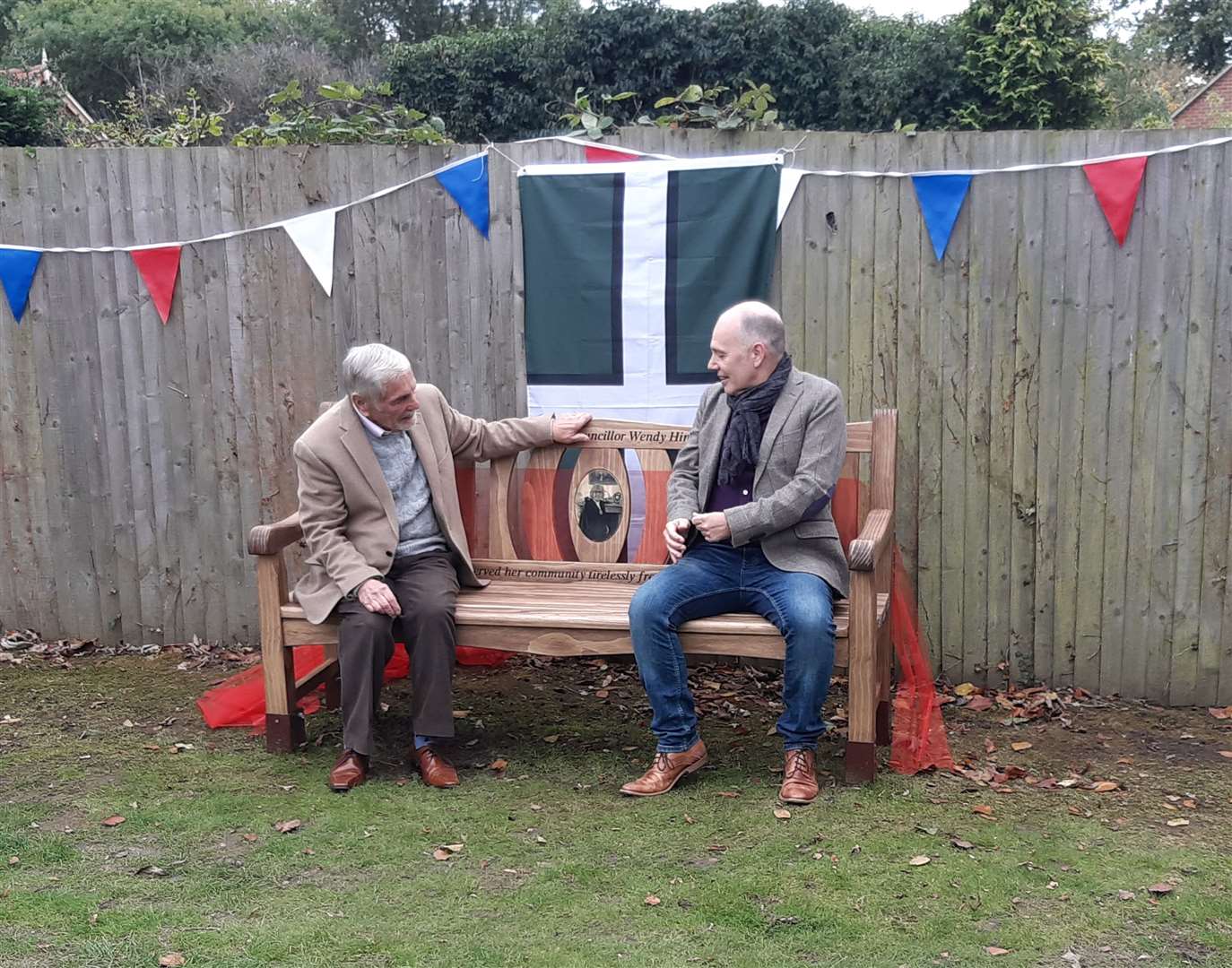 Cllr Bob Hinder tries out the bench with his son Andrew