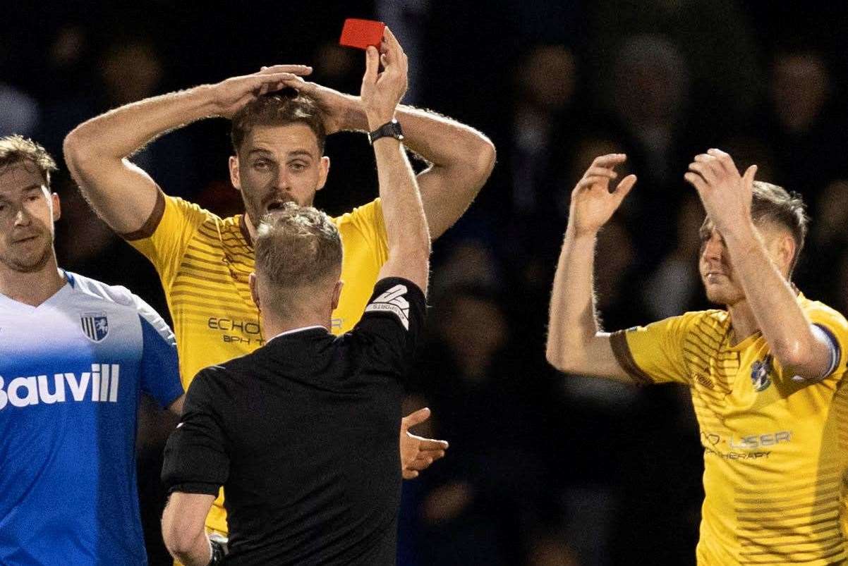 Sutton's Harry Smith is shown a red card at Gillingham by referee David Rock. Picture: @Julian_KPI