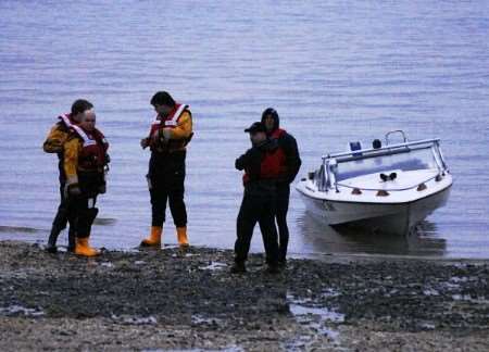 A Whitstable lifeboat shore party with the broken down speedboat after it was brought ashore. Picture: RNLI Whitstable