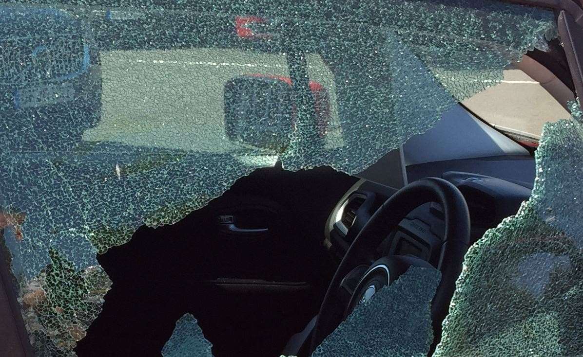 A car window was smashed to free the dog. Stock image.