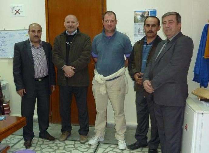 Barry Manners with workers at Dukan Dam, where he was held during his time in captivity, during a visit to Iraq in 2011