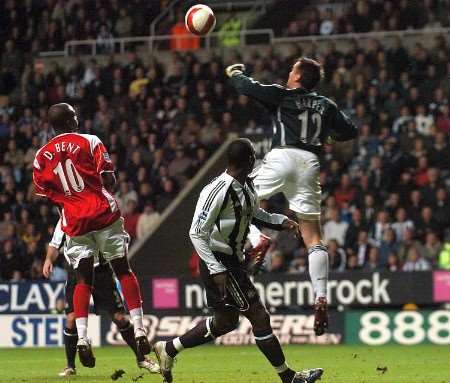 Newcastle keeper Steve Harper punches the ball out of Darren Bent's reach. Picture: MATT WALKER