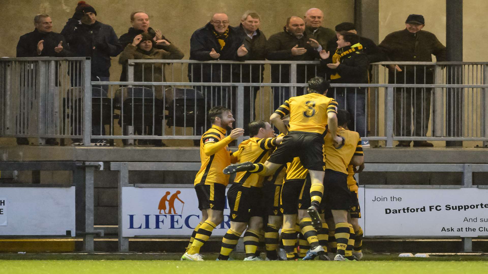 Alex Flisher is mobbed by his team-mates after scoring Maidstone's goal Picture: Andy Payton