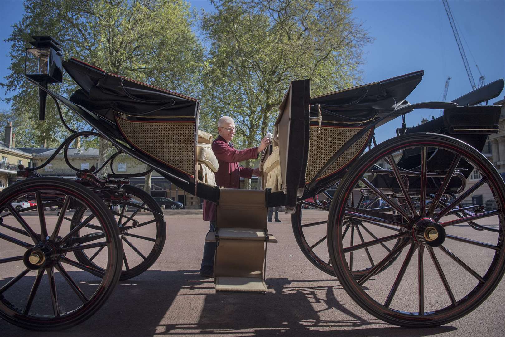Martin Oates, senior carriage restorer, polishes the Ascot Landau, which will be used in the case of dry weather at the wedding of Prince Harry and Meghan Markle Picture: Victoria Jones/PA Wire
