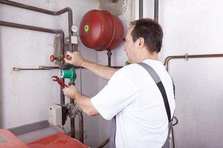 Boiler repair file picture. Heating engineer at work