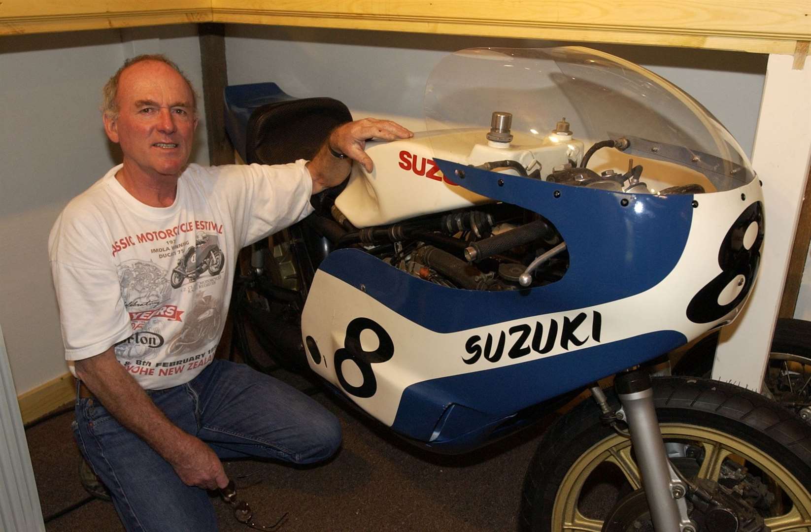 Former motorcycle racer Paul Smart with one of his old race bikes