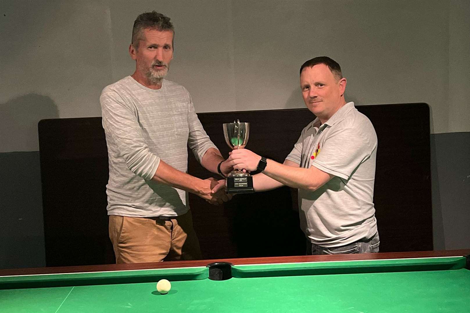 Aylesford club secretary Les Girling, left, presents the trophy to Simon Gillham