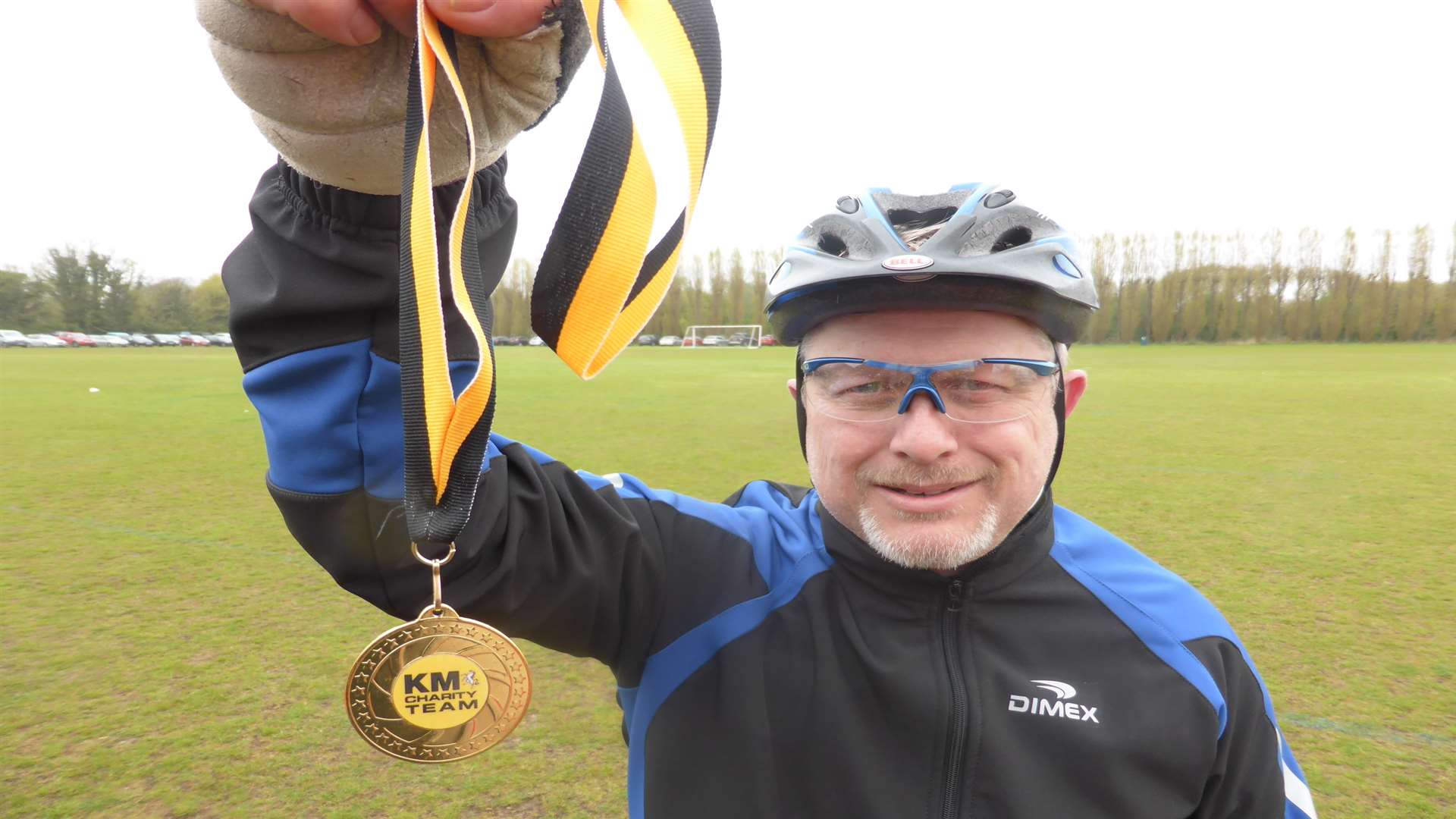 Andy Bellingham of Ramsgate celebrates completing the KM Big Bike Ride 2015 with his medal.