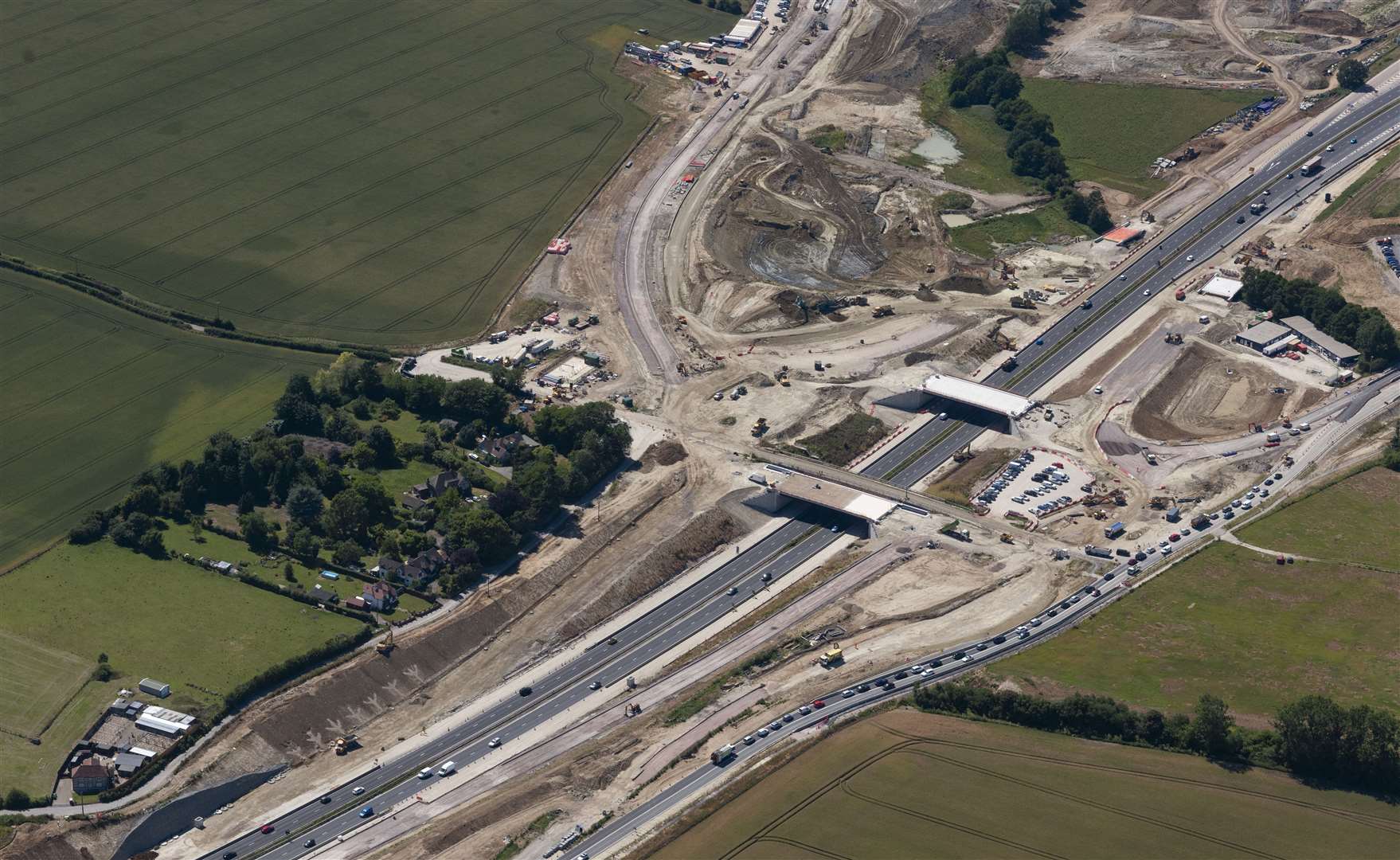 The new bridges which will form Junction 10a were put in earlier this year. In this photo, traffic can be seen queuing on the A20 where temporary traffic lights have sparked delays. Picture: Ady Kerry / Ashford Borough Council