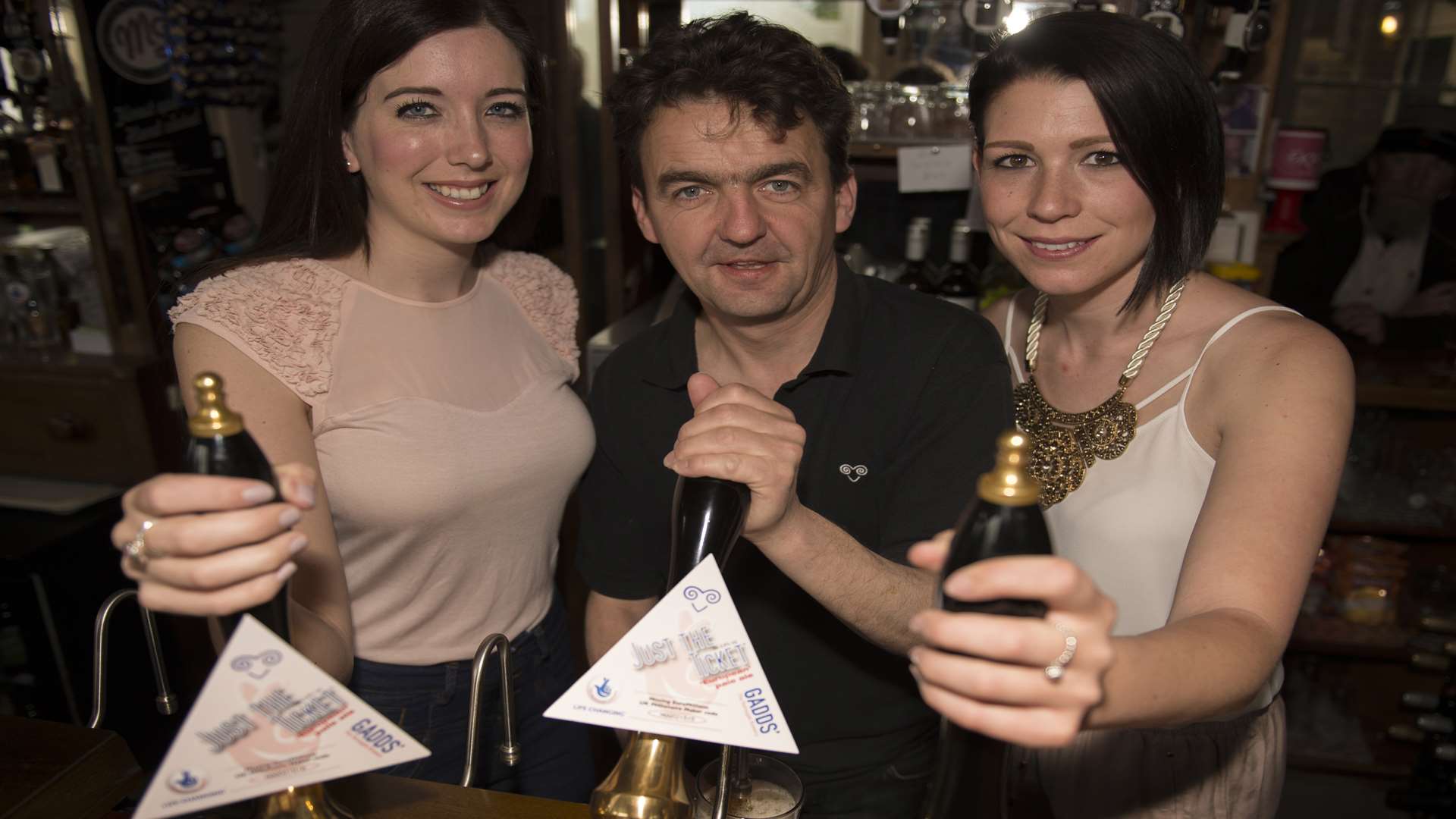 Past EuroMillions winners Becky Witt (left) and Carly Wiggett (right) with Ramsgate brewer Eddie Gadd in the Montefiore Arms.