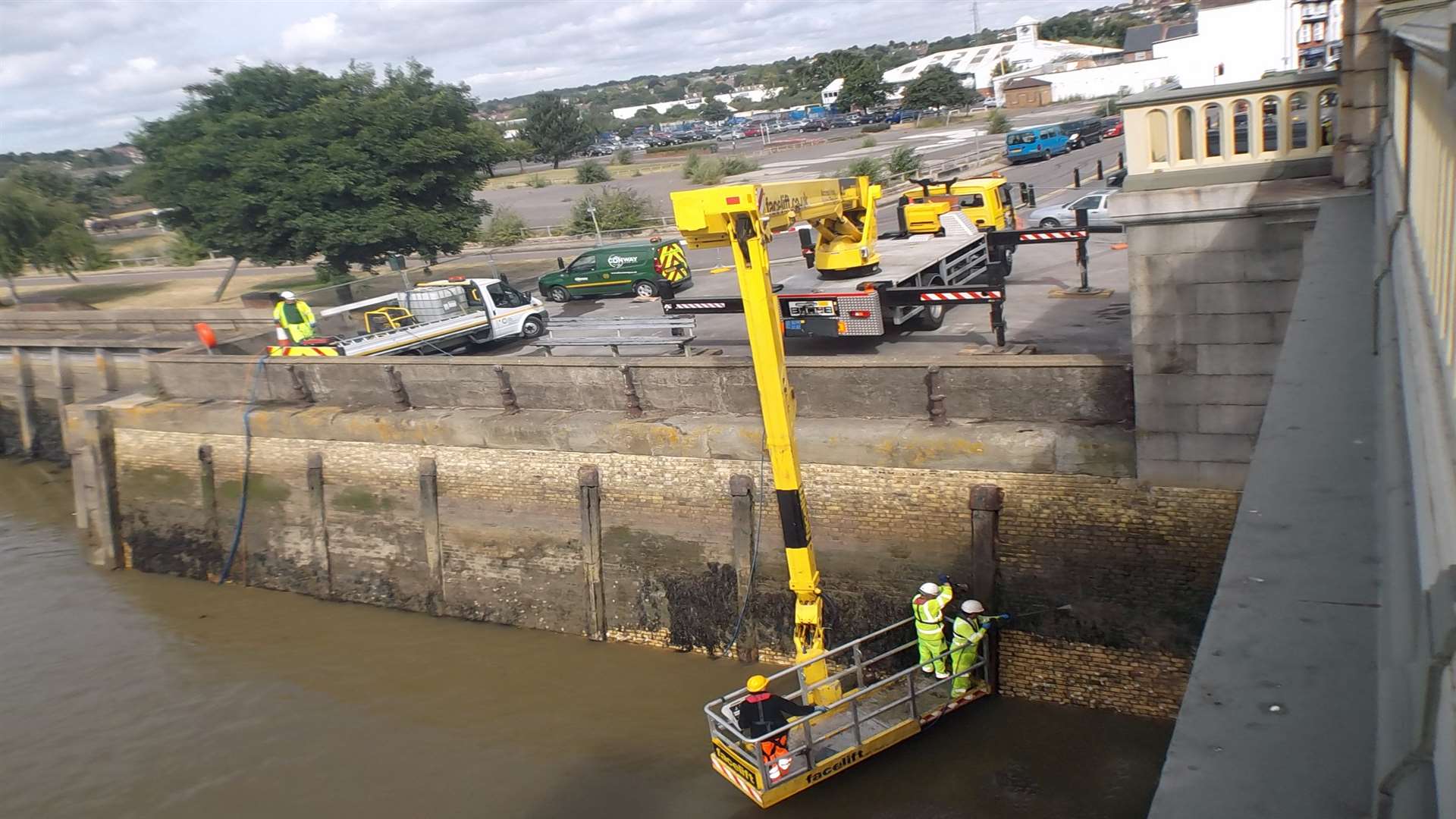 Seaweed and water deposits are washed off Rochester Bridge Trust embankments