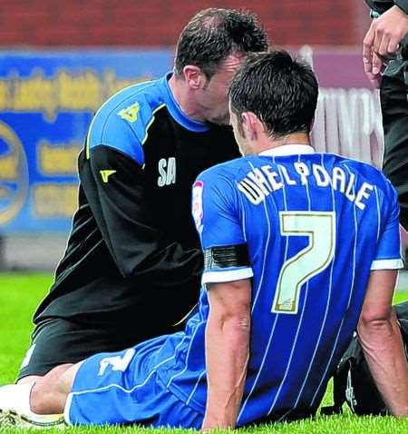 Chris Whelpdale receives treatment at Crewe