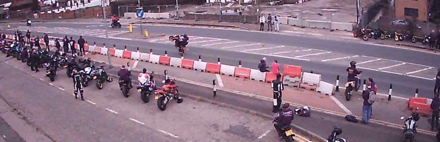 Motorcyclists perform stunts along the stretch