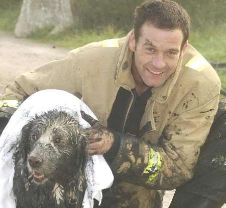 IN SAFE HANDS: Ellie with leading firefighter Paul Foster after her ordeal. Picture: BARRY CRAYFORD