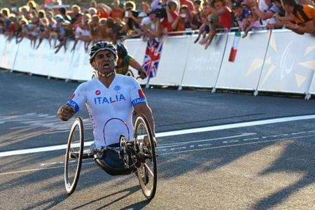 Alex Zanardi crosses the line to secure the Road Race gold medal