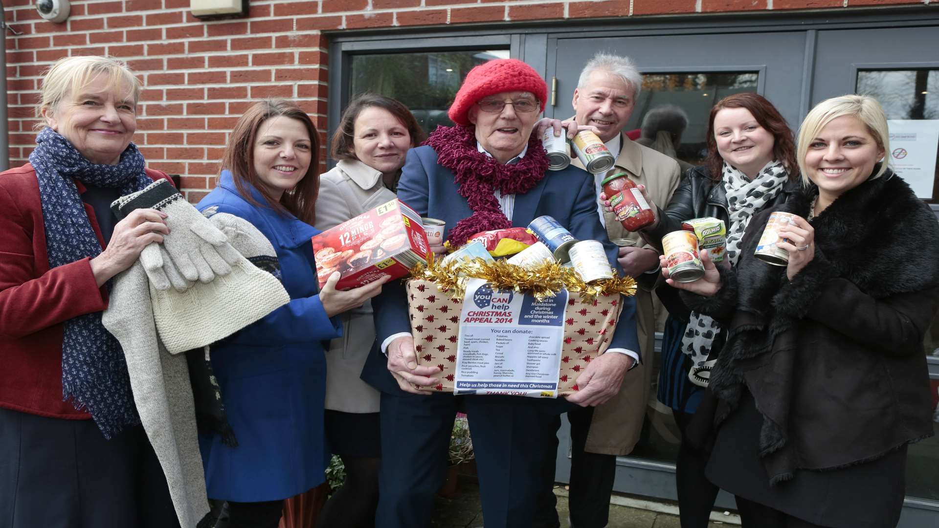 The KM staff hand over donations to the You Can Help appeal to trustees Mike FitzGerald (centre) and Angela Clay (first left) at the day centre