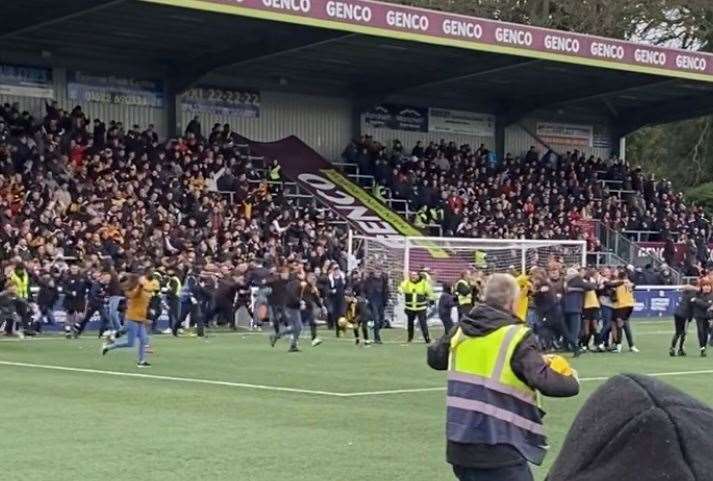 Fans invading the pitch after Maidstone United's FA cup win
