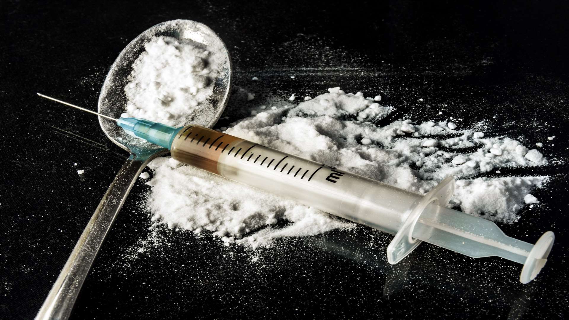 Drug syringe and heroin on a spoon. ISTOCK/Getty Image