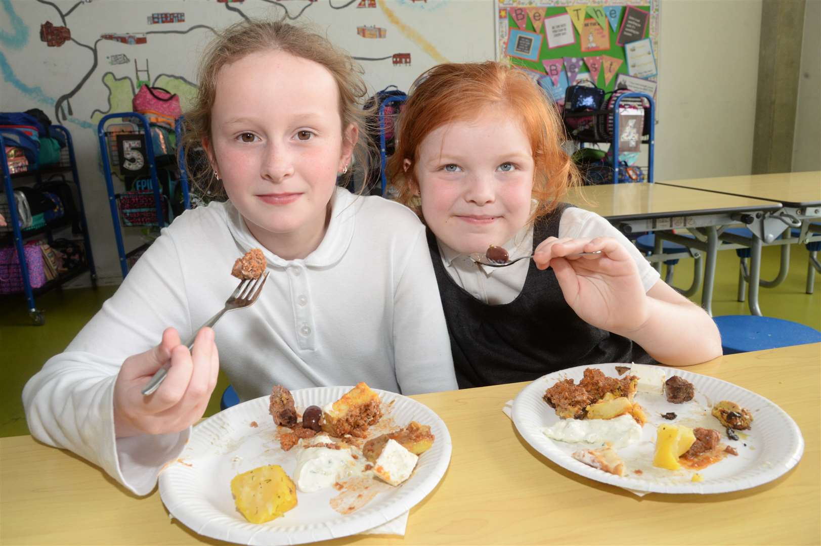 Rebecca and Molly, both eight, tasting Greek cuisine at Halfway Houses Primary School