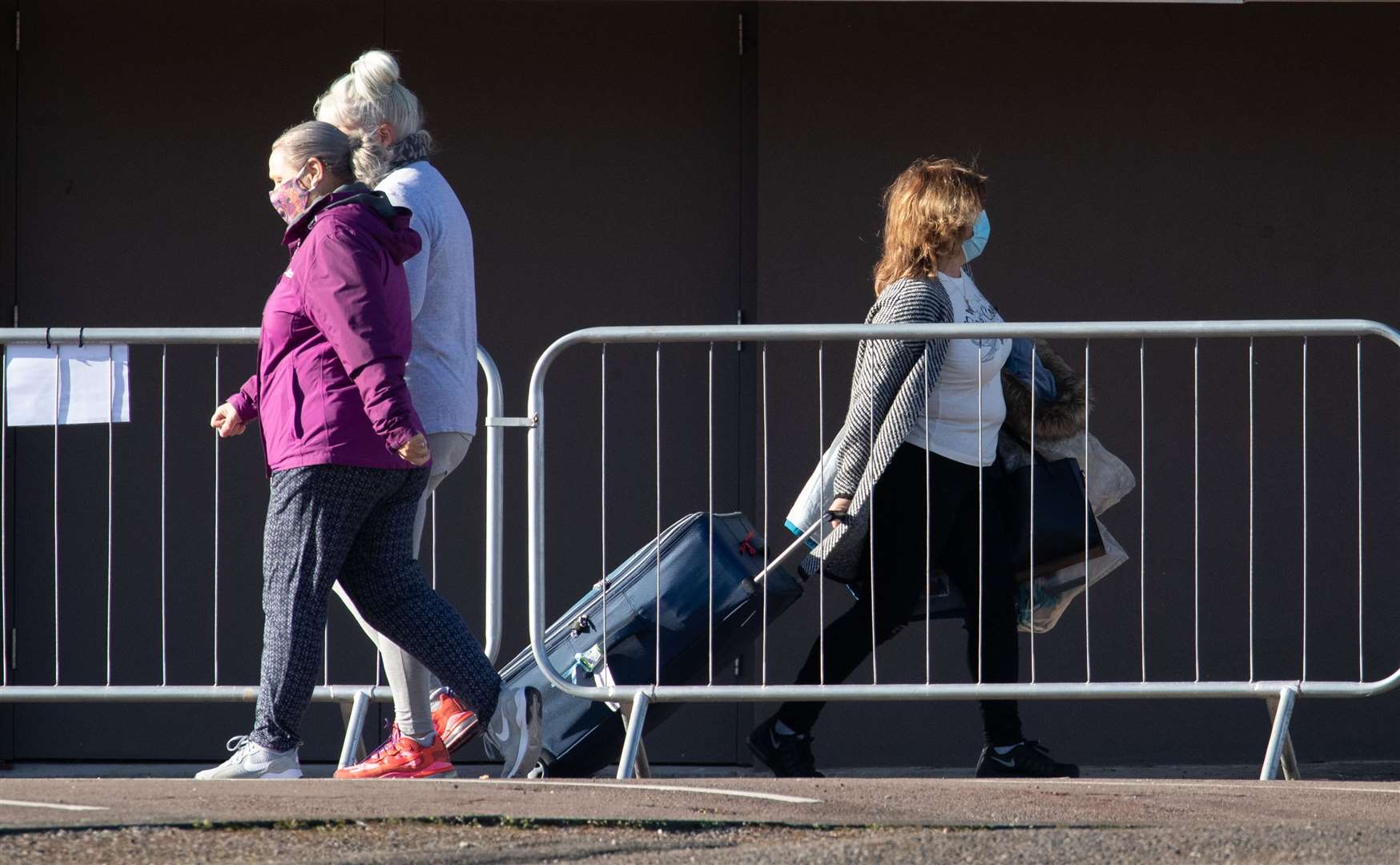Guests take part in their daily exercise, left, as another, right, leaves the Radisson Blu Edwardian hotel near Heathrow Airport (Andrew Matthews/PA)