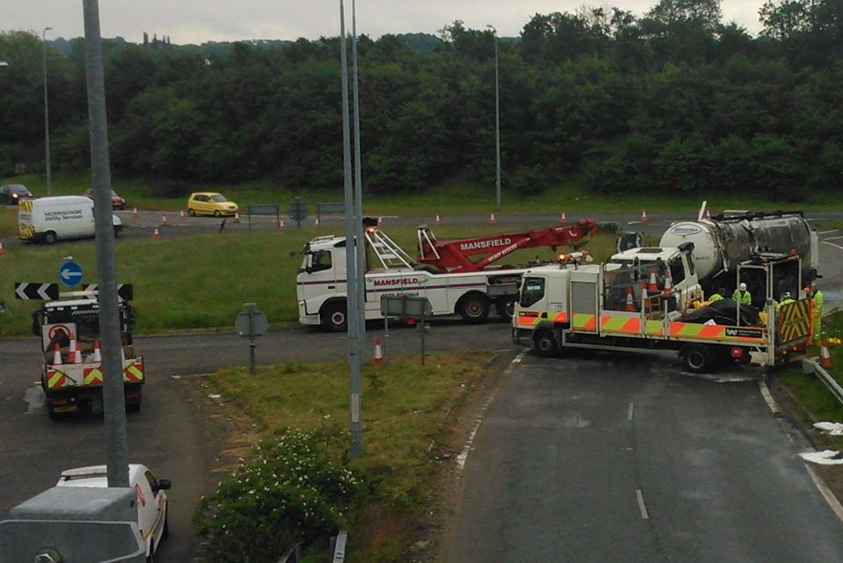 Emergency crews help remove the tanker. Picture: Martin Weeks