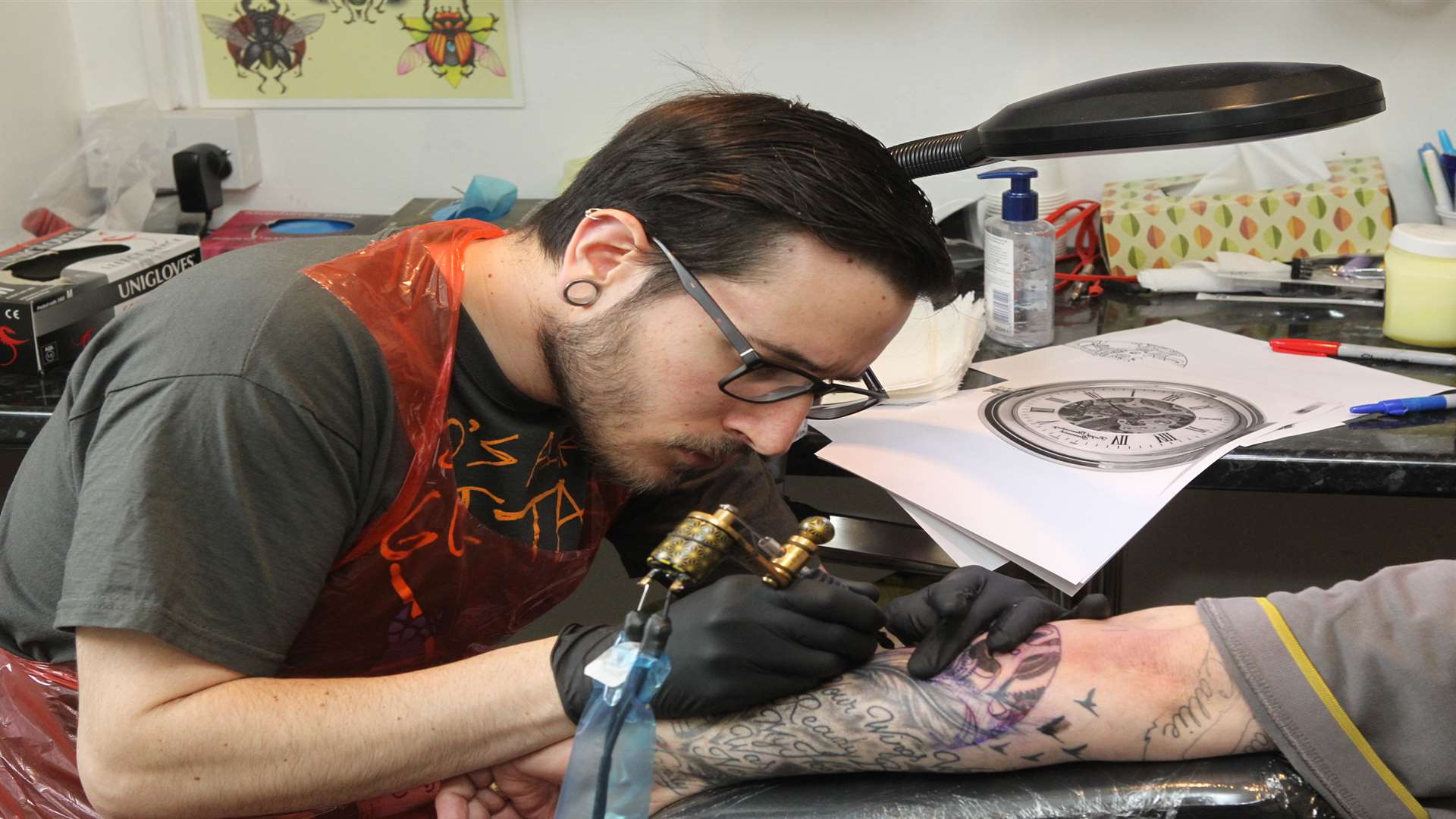 Tattooist David Chicote at work at Ravens Nest Tattoo Salon in Gravesend
