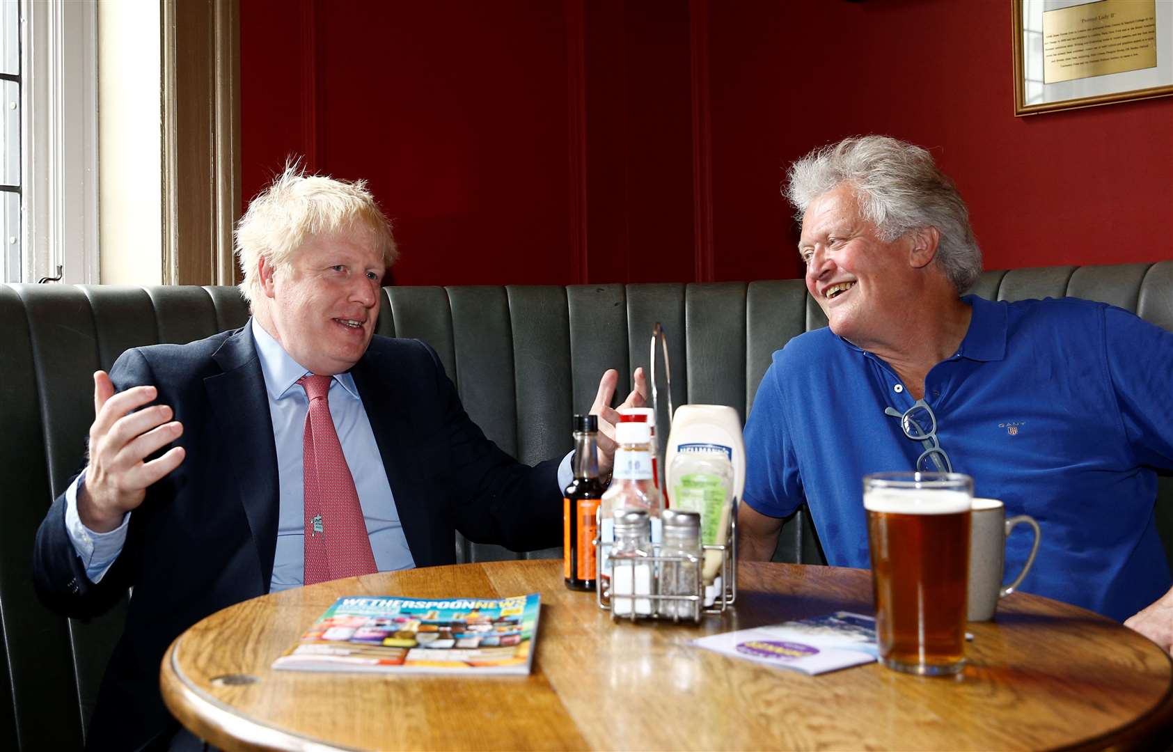 Tim Martin (right) in happier times, will introduce screens in pubs and remove shared condiments from tables. (Henry Nicholls / PA)