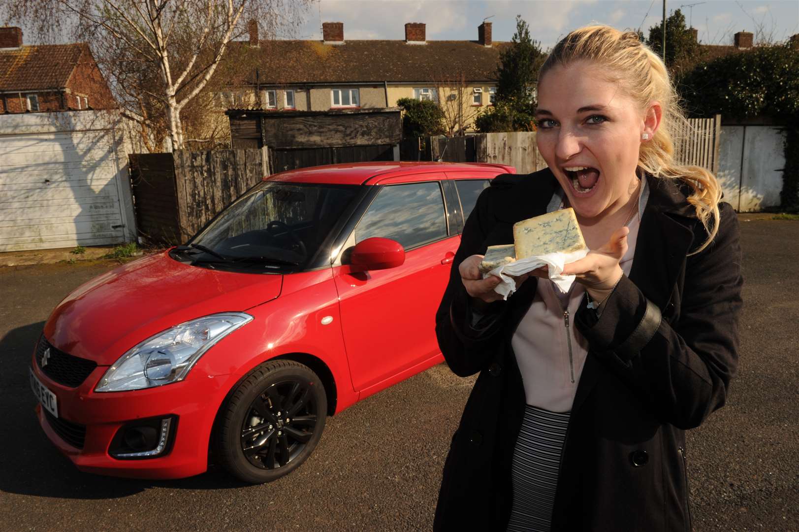 Ellie Crewe with her prize winnings, including a car and blue cheese.