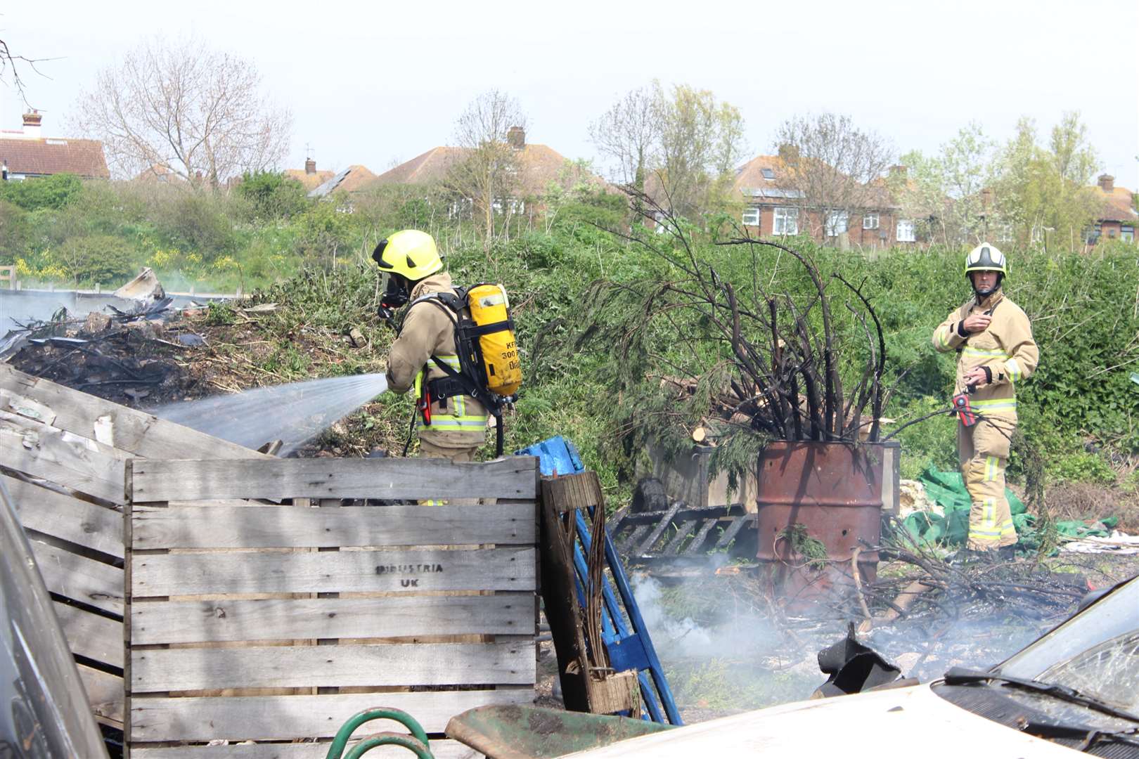 Fire-fighters using breathing gear tackle the blaze at Monkey Farm car-breakers, Sheerness