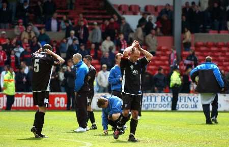 Gillingham's players are dejected after being relegated at the City Ground on May 8 last year. Picture: BARRY GOODWIN