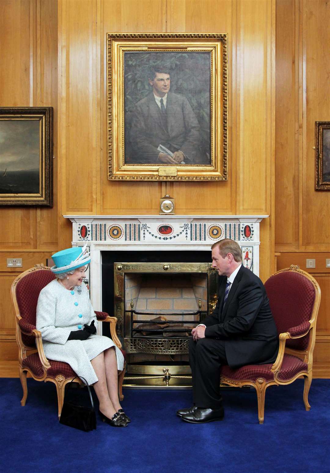 Queen Elizabeth II and Taoiseach Enda Kenny under a portrait of Michael Collins, in Government Buildings, Dublin (Maxwells/PA)