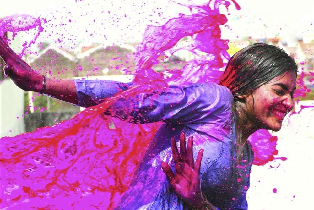 Colourful paints and water are splashed during Holi