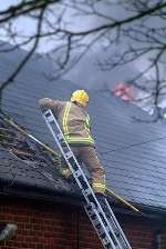 Firefighters bring the blaze under control. Picture: GARY BROWNE