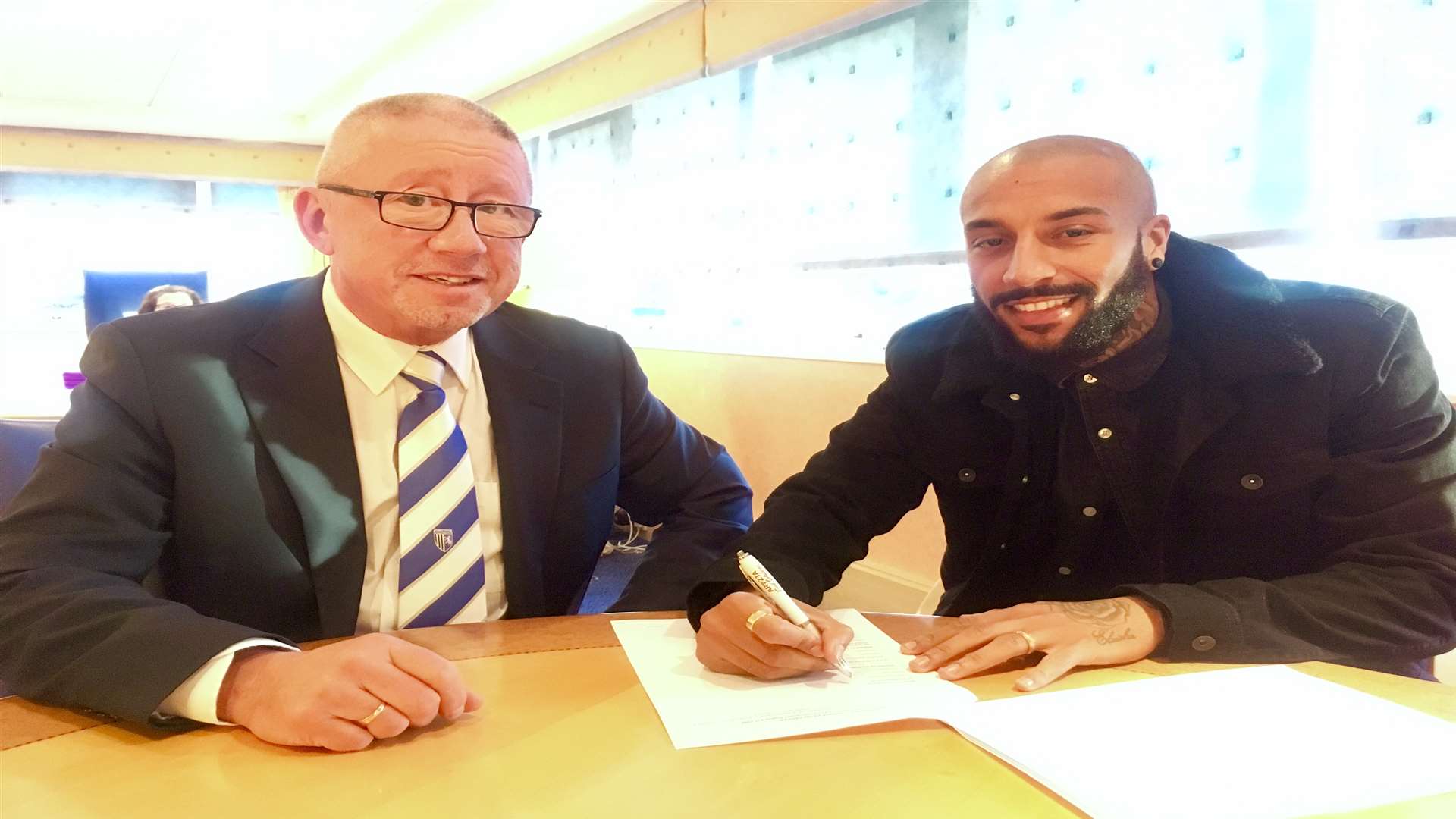 Gills chairman Paul Scally with new signing Josh Parker Picture: GFC