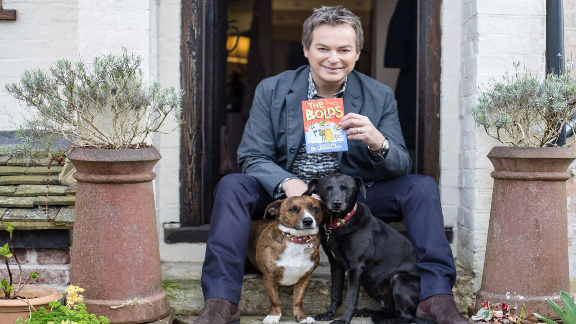 Julian Clary with his World Book Day The Bolds book at home in Kent with his dogs
