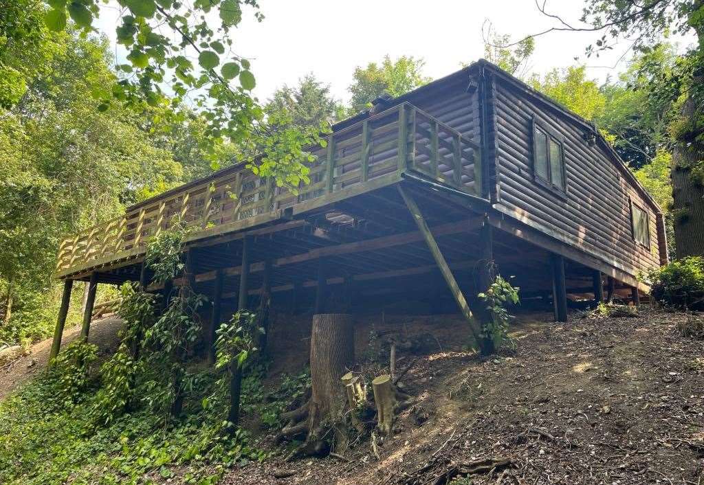 The log cabin has a balcony with far-reaching views
