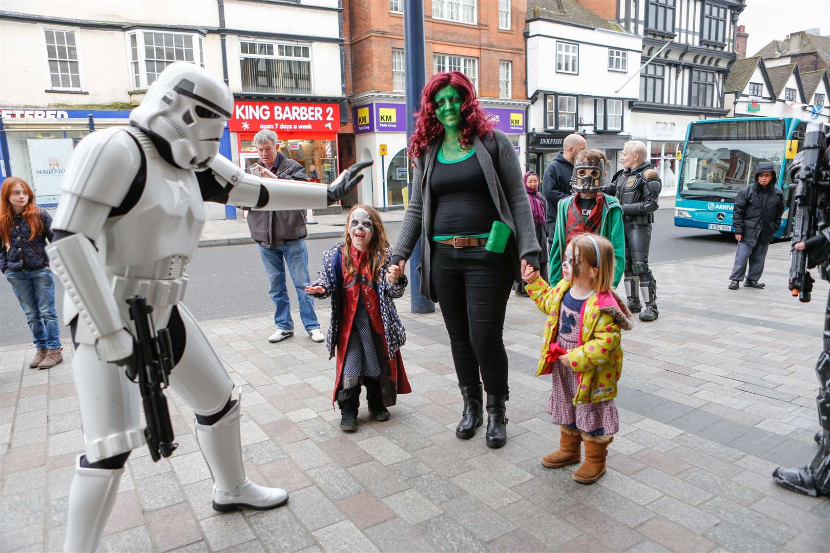 Violet and Molly Hayton hold mum Katie's hand as they come face to face with a Stormtrooper. Picture: Matthew Walker
