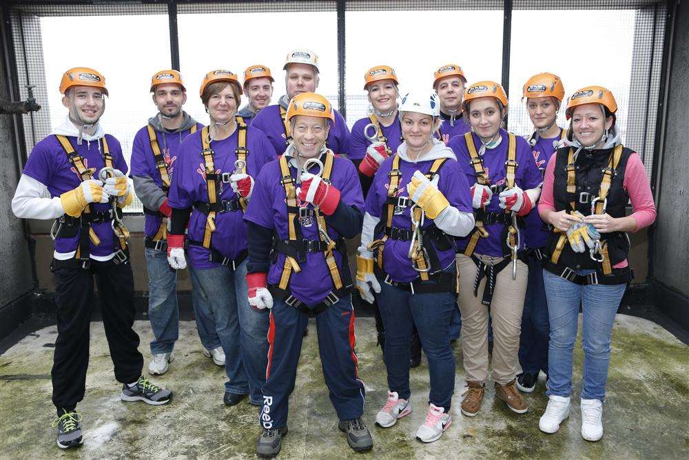 The first group of abseilers pre are for their descent, including Stacey's dad Warren Mowle and grandad Bob Mowle
