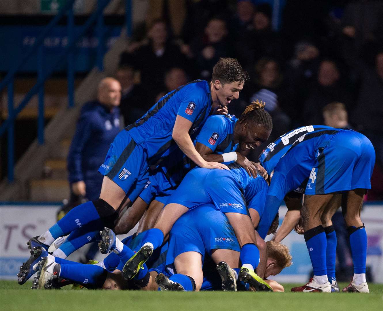 Gills players bundle Elliott List in celebration after his 81st minute winner. Pictures: Ady Kerry
