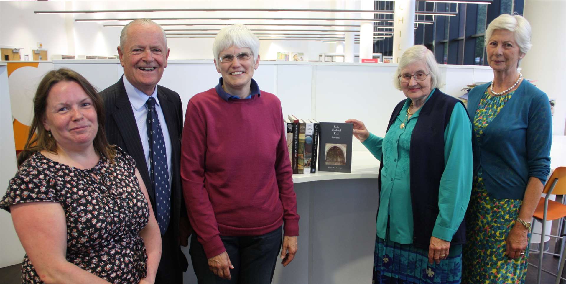 Dr Felicity Simpson adds the tenth and final volume to the project watched by, from left, Sarah Stanley, Mike Hill, Dr Sheila Sweetinburgh and Mrs Sarah Hohler.