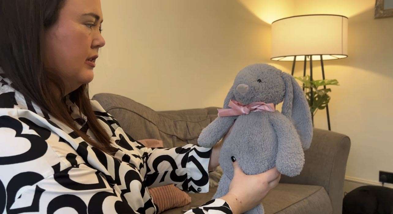 Lizzie Phillips, 31 with the teddy that holds her baby's heartbeat