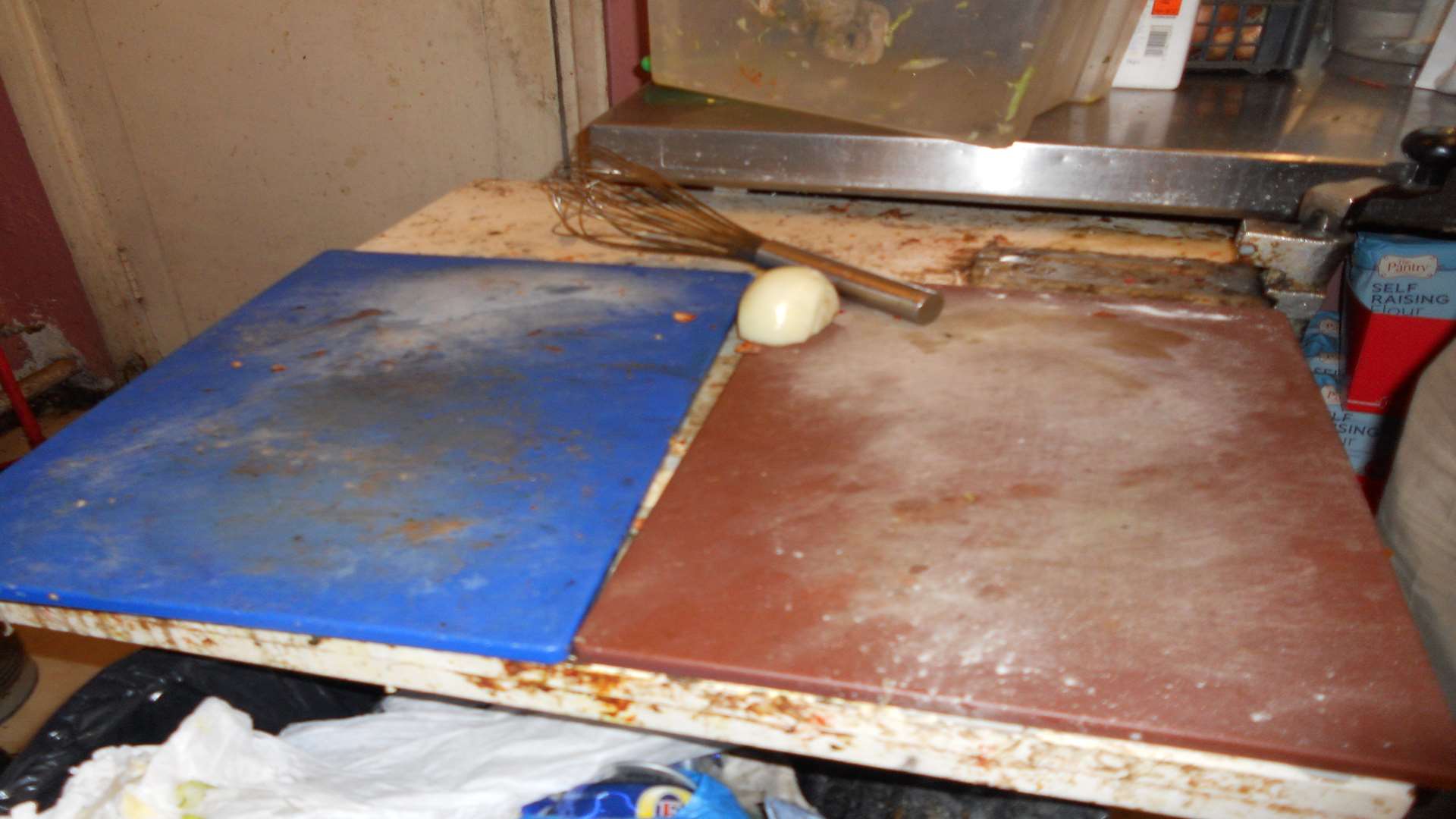 Inspectors look at the cleanliness of surfaces and appliances during their a to a food outlet