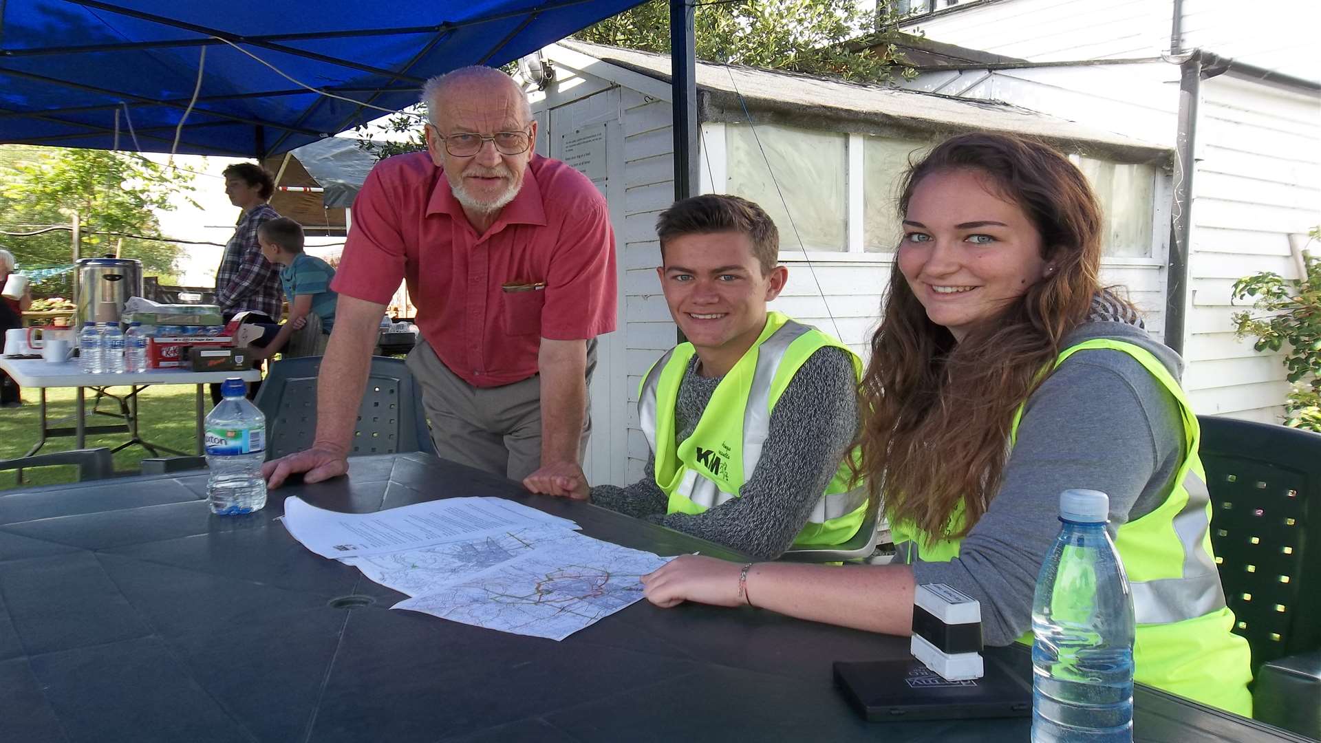 Derek Cole, landlord of the Shipwright's Arms in Hollowshore, Faversham, is briefed by stamping station volunteers Jack Grieve (17) and Rebecca Mansfield (16) of Barton Court Grammar School