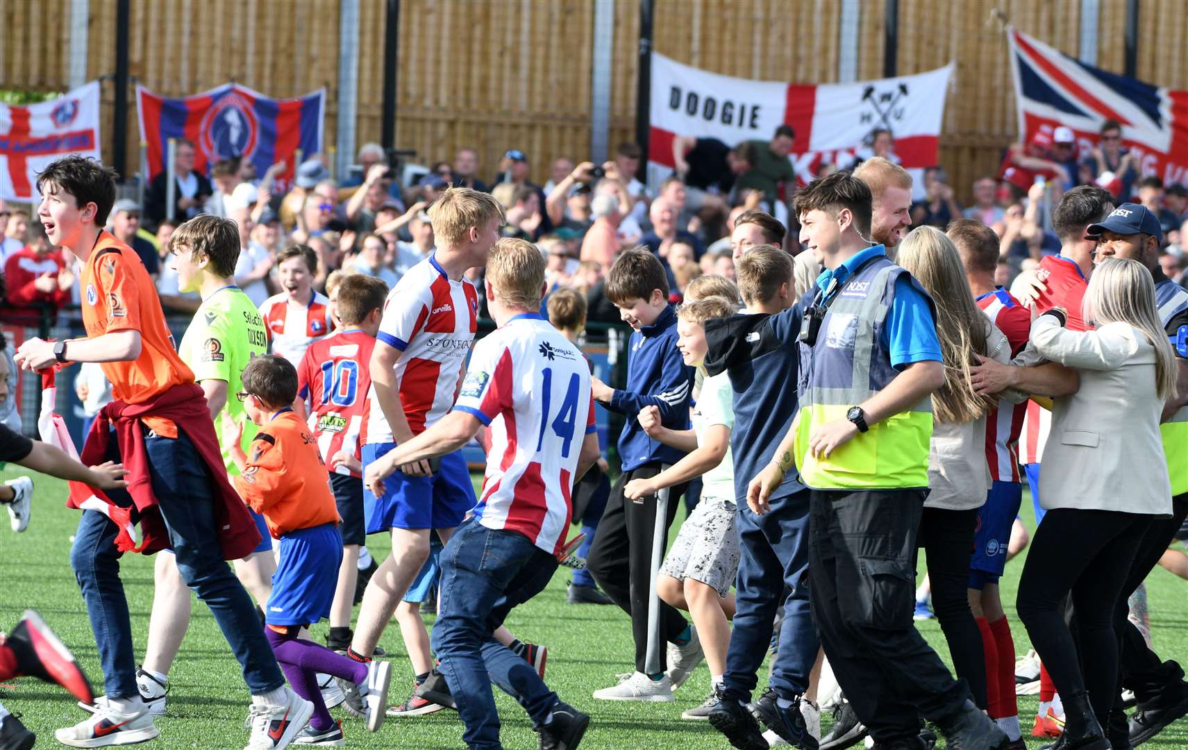 Dorking Wanderers fans rush on to celebrate their victory at the final whistle. Picture: Barry Goodwin